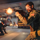 A screenshot from Call of Duty: Cold War, showing a Russian soldier firing a machinegun.